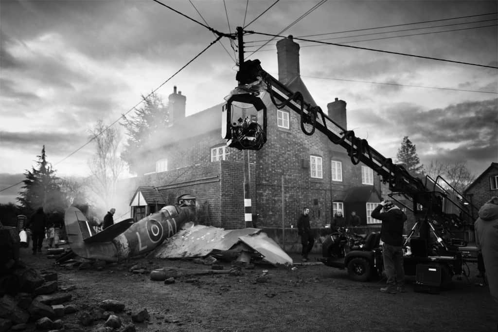 A behind the scenes photo of a plane crashing into a building. Taken by unit stills photographer, Aimee Spinks